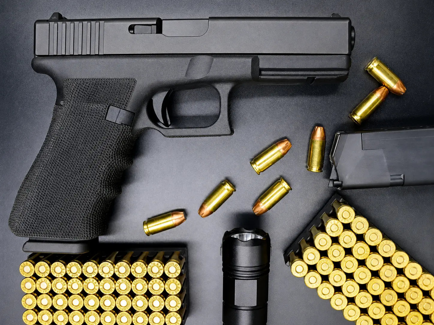 Pistol and ammunition laid out on a bench before applying solvent and oil
