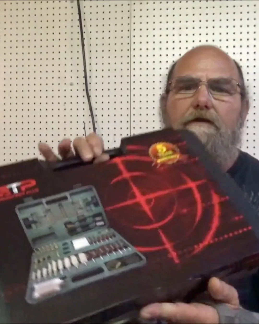GuardTech Plus customer holding a red gun cleaning kit